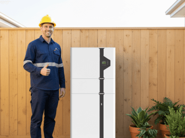 Battery installation by a professional electrician with safety gear