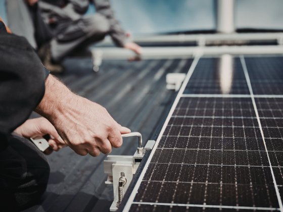 Solar panel installation technician securing panels to a residential rooftop in Perth, WA – Ares Energy & Electricals